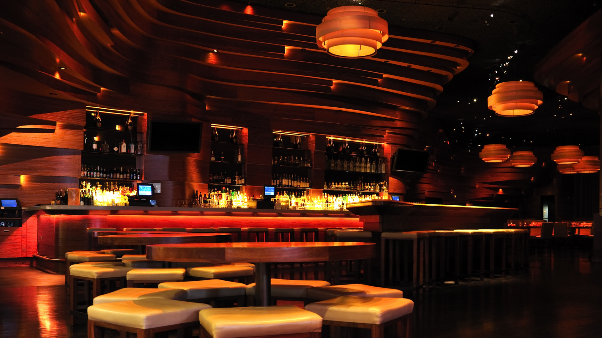 Sophisticated upscale bar interior with warm lighting, modern design, and premium atmosphere showcasing our store operation support services